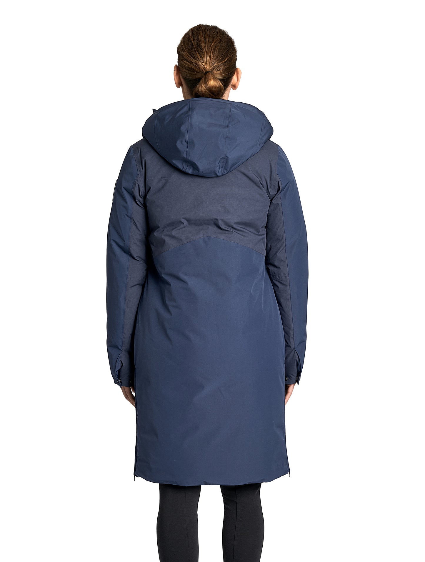 Inara Women's Performance Parka in knee length, premium 3-ply micro denier and stretch ripstop fabrication with DWR coating, Premium Canadian White Duck Down insulation, non-removable down-filled hood, centre front two-way zipper, large vertical zipper pockets along waist, zipper vents along bottom side hem, in Marine