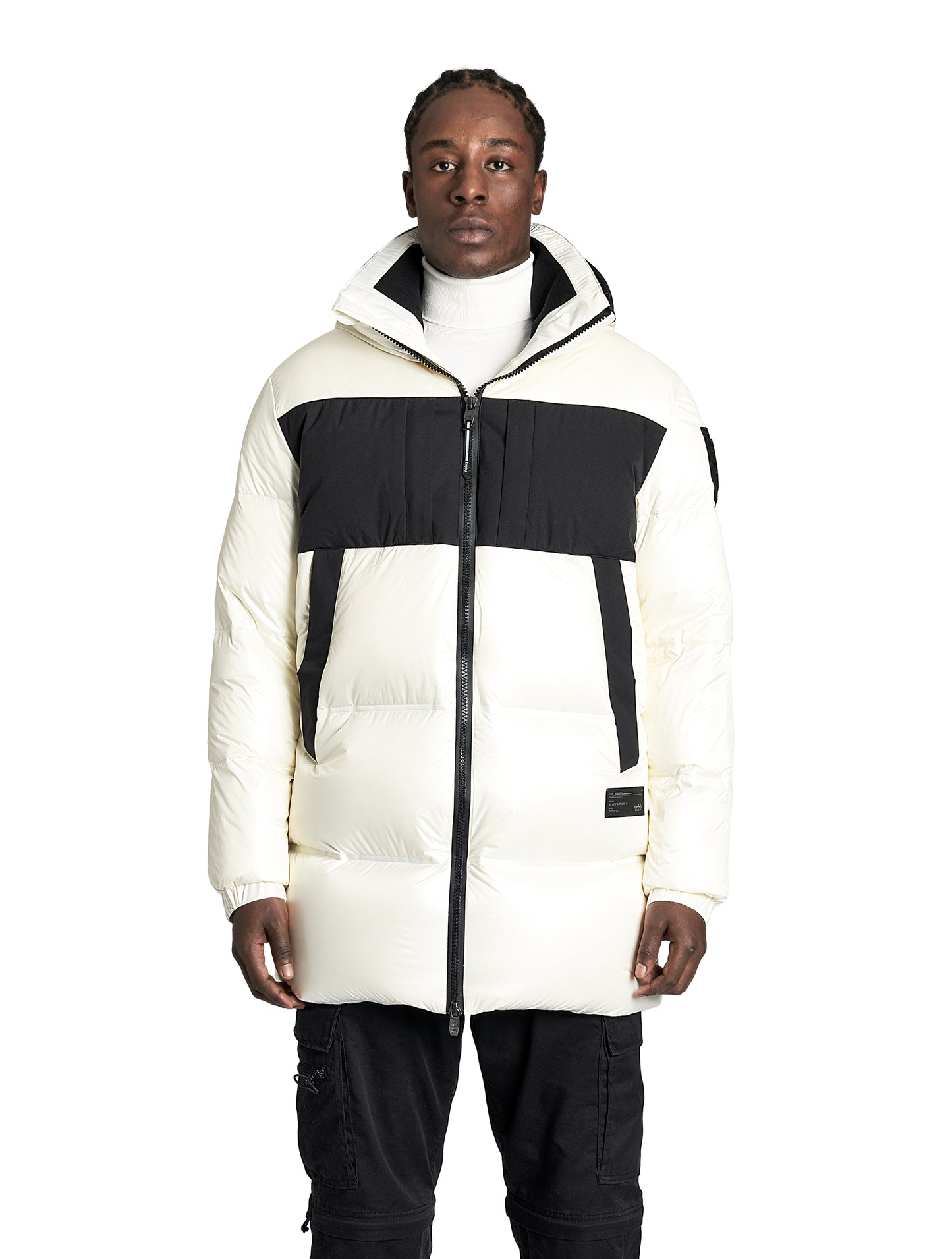 Neelix Men's Long Puffer Jacket in thigh length, premium cire technical nylon taffeta and stretch ripstop fabrication, Premium Canadian origin White Duck Down insulation, non-removable down-filled hood, two-way centre-front zipper, pit zipper vents, hidden chest zipper pockets, fleece-lined magnetic closure waist pockets, in Chalk