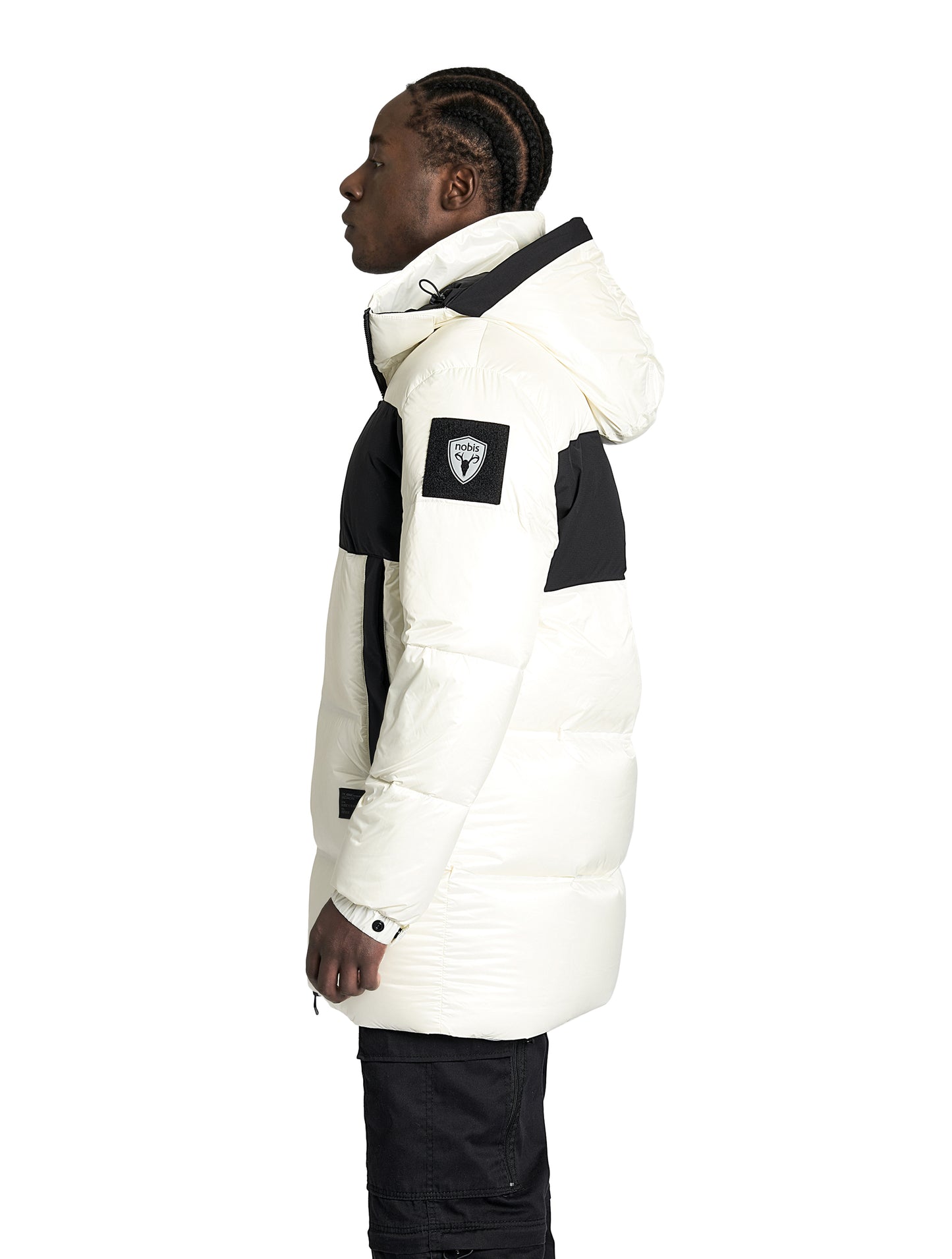 Neelix Men's Long Puffer Jacket in thigh length, premium cire technical nylon taffeta and stretch ripstop fabrication, Premium Canadian origin White Duck Down insulation, non-removable down-filled hood, two-way centre-front zipper, pit zipper vents, hidden chest zipper pockets, fleece-lined magnetic closure waist pockets, in Chalk
