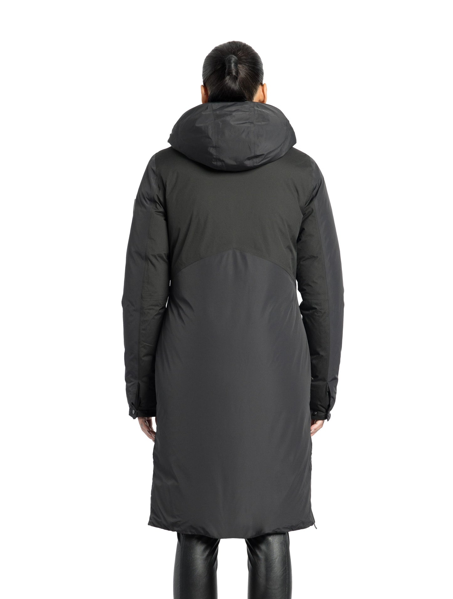 Inara Women's Performance Parka in knee length, premium 3-ply micro denier and stretch ripstop fabrication with DWR coating, Premium Canadian White Duck Down insulation, non-removable down-filled hood, centre front two-way zipper, large vertical zipper pockets along waist, zipper vents along bottom side hem, in Black