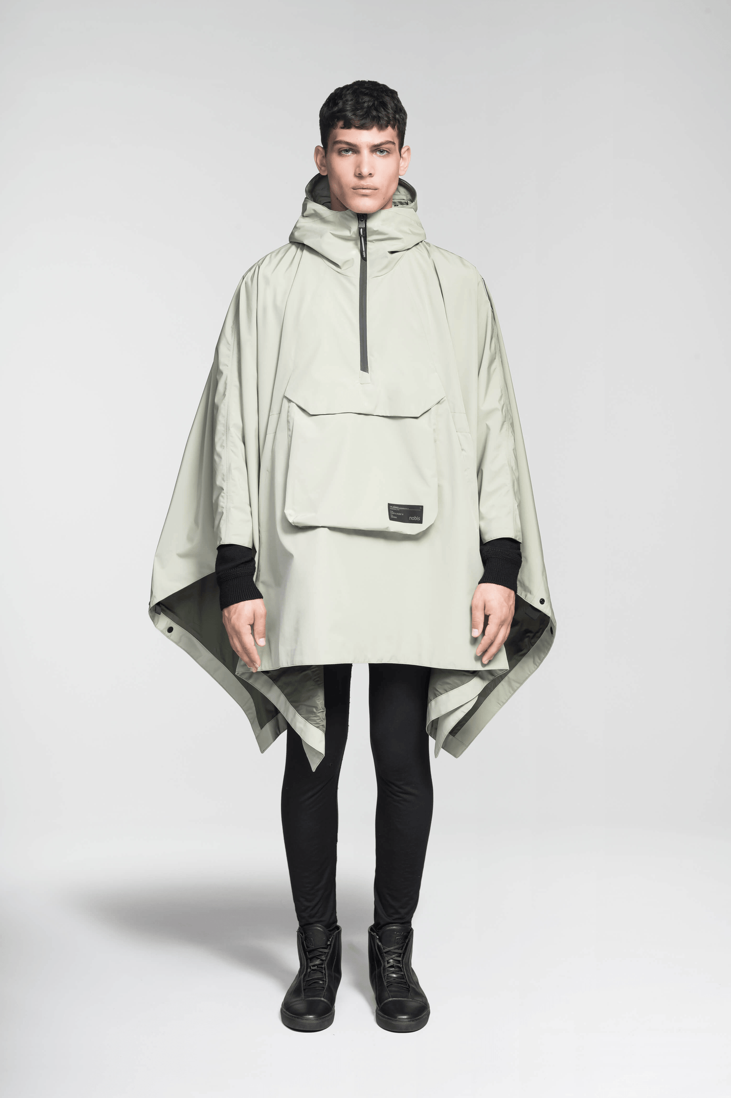 Hydra Unisex Performance Poncho in thigh length, non-removable hood, vertical half-zipper along centre front collar, hidden side-entry waist zipper pockets, adjustable webbing straps and snap closure cuffs, and packable to front kangaroo pocket with flap opening, in Tea
