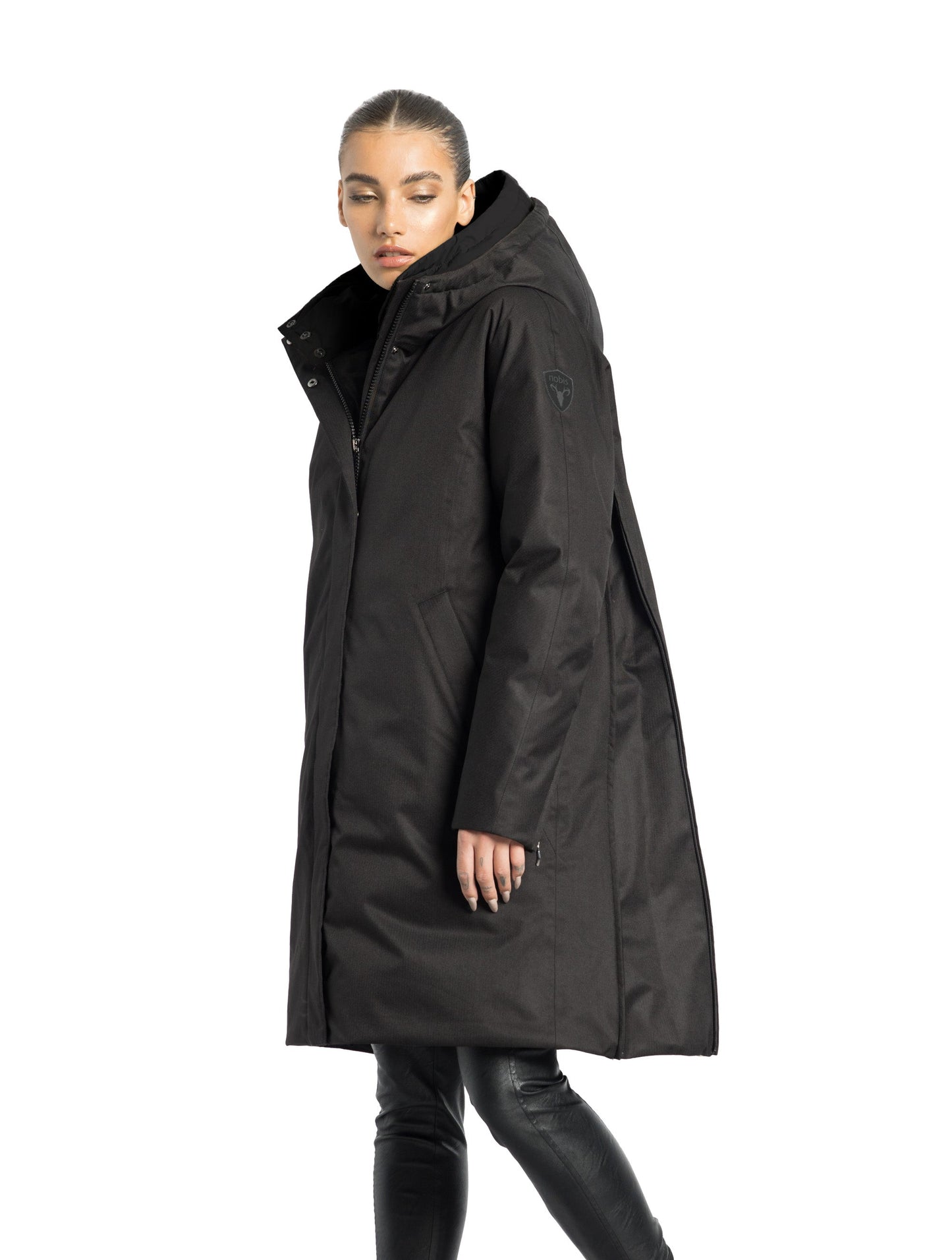 Dory Women's Tailored Back Zip Parka in knee length, premium Crosshatch fabrication, Premium Canadian White Duck Down insulation, non-removable down-filled hood, removable interior hood, centre front two-way zipper with wind flap, vertical zipper detailing along back, in Black