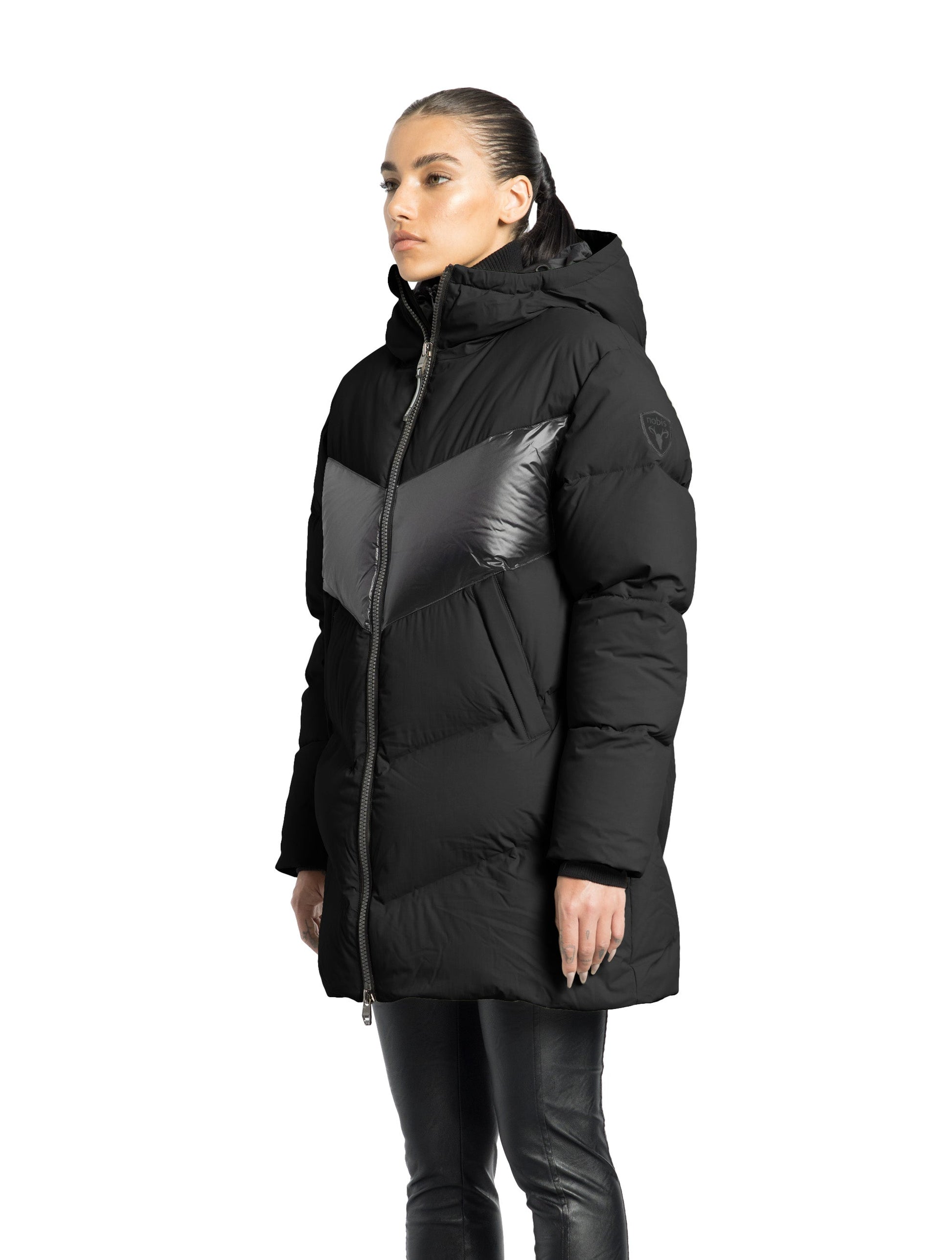 Isla Women's Chevron Quilted Puffer Jacket in thigh length, premium technical nylon taffeta fabrication, Premium Canadian origin White Duck Down insulation, non-removable down-filled hood, two-way centre-front zipper, zipper pockets at waist, contrast cire technical nylon taffeta detailing on chest and back, in Black