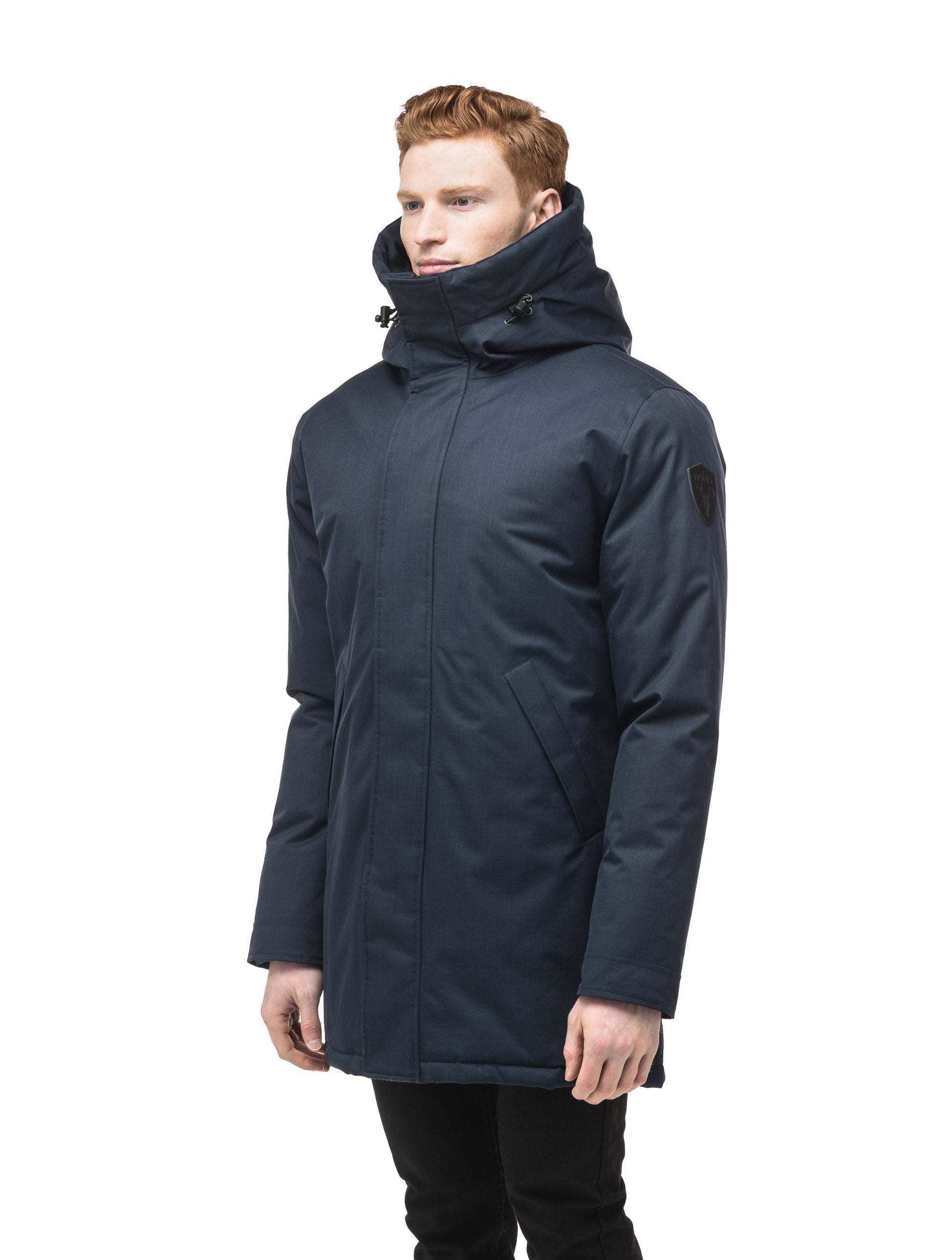 Pierre Men's Jacket in thigh length, Canadian white duck down insulation, non-removable down-filled hood, angled waist pockets, centre-front zipper with wind flap, and elastic ribbed cuffs, in Navy