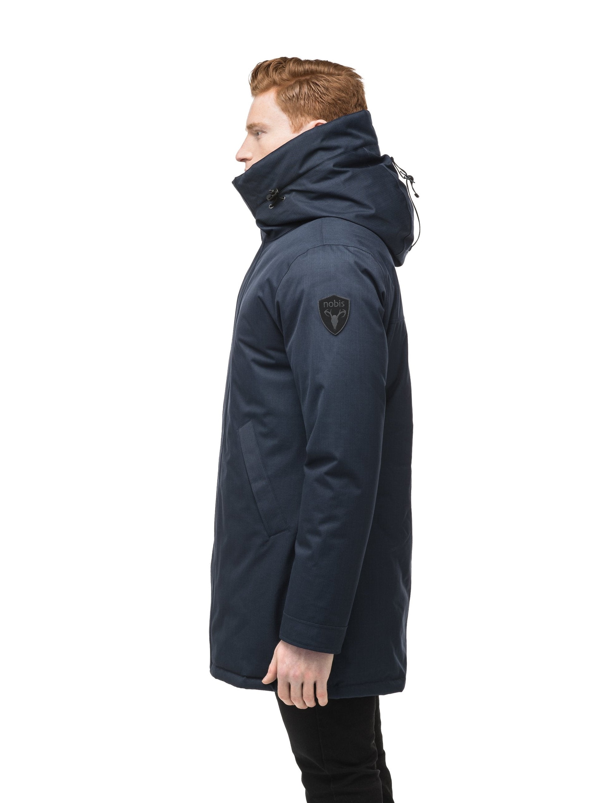 Pierre Men's Jacket in thigh length, Canadian white duck down insulation, non-removable down-filled hood, angled waist pockets, centre-front zipper with wind flap, and elastic ribbed cuffs, in Navy