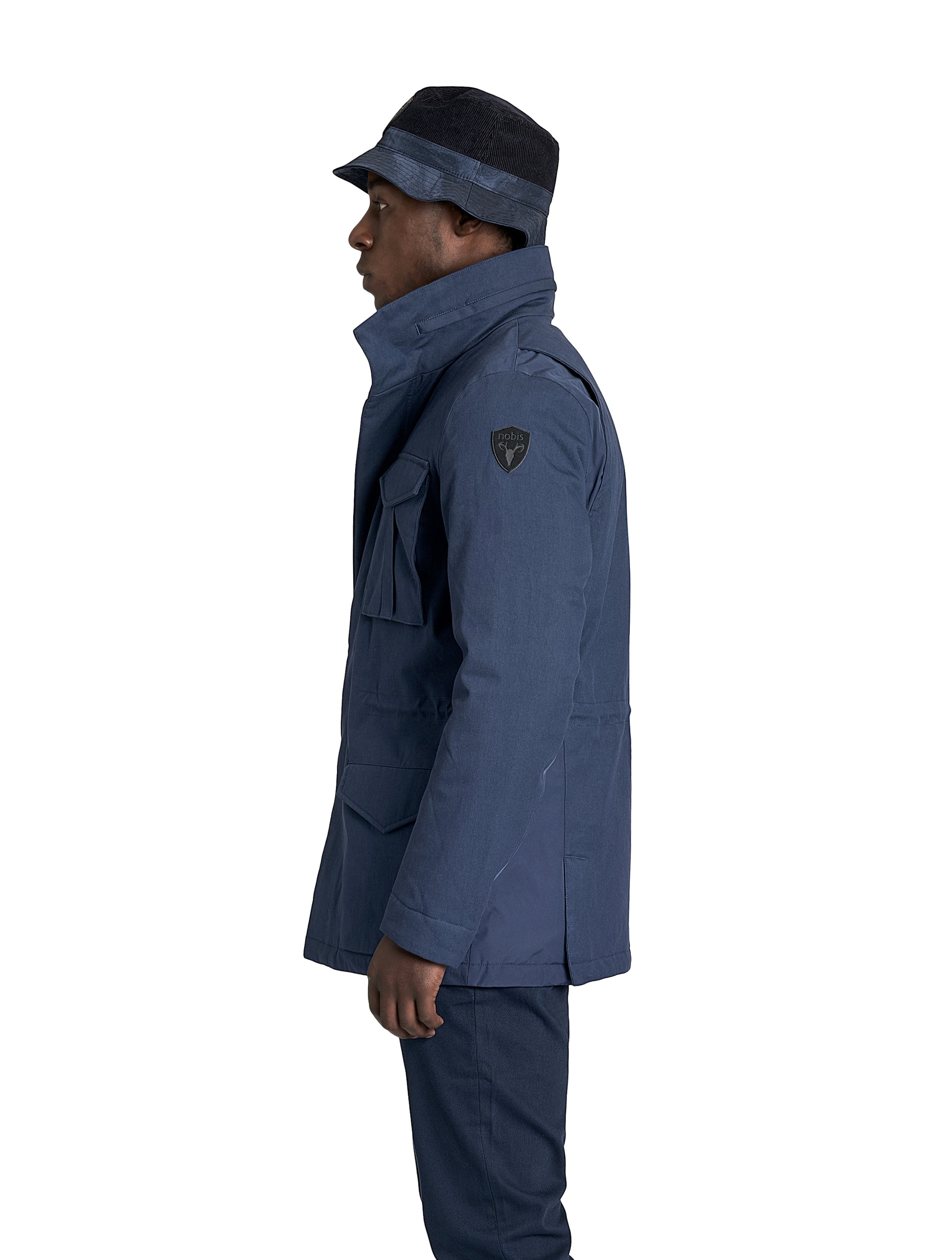 Pelican Men's Tailored Field Jacket in hip length, premium cotton blend and 3-ply micro denier fabrication, Premium Canadian origin White Duck Down insulation, tuck away, waterproof hood in premium cire technical nylon taffeta, two-way centre-front zipper with magnetic wind flap, pit zipper vents, magnetic closure chest and waist flap pockets, hidden adjustable waist drawcord, and action back detailing, in Navy