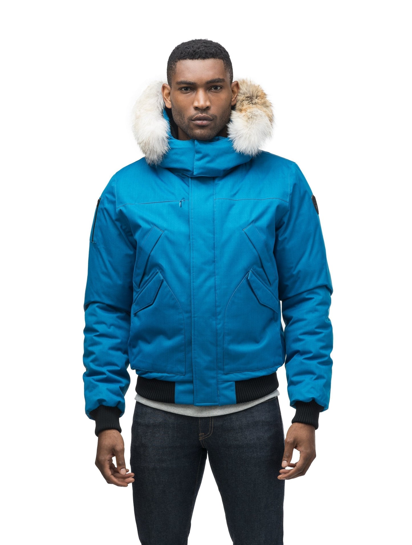 Men's classic down filled bomber jacket with a down filled hood that features a removable coyote fur trim and concealed moldable framing wire in Sea Blue
