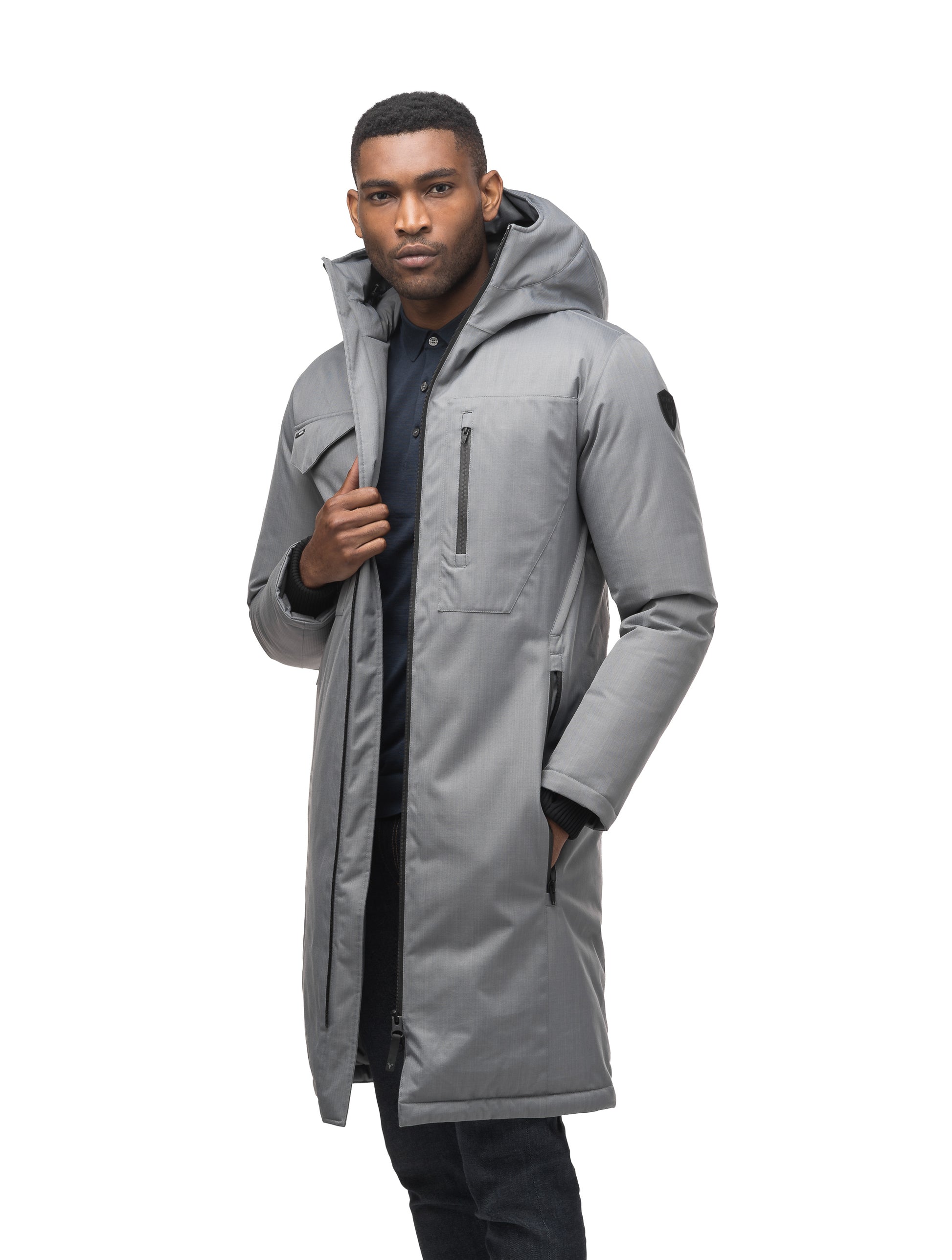 Long men's calf length parka with down fill and exposed zipper that features spacious pockets and zippered vents in Concrete