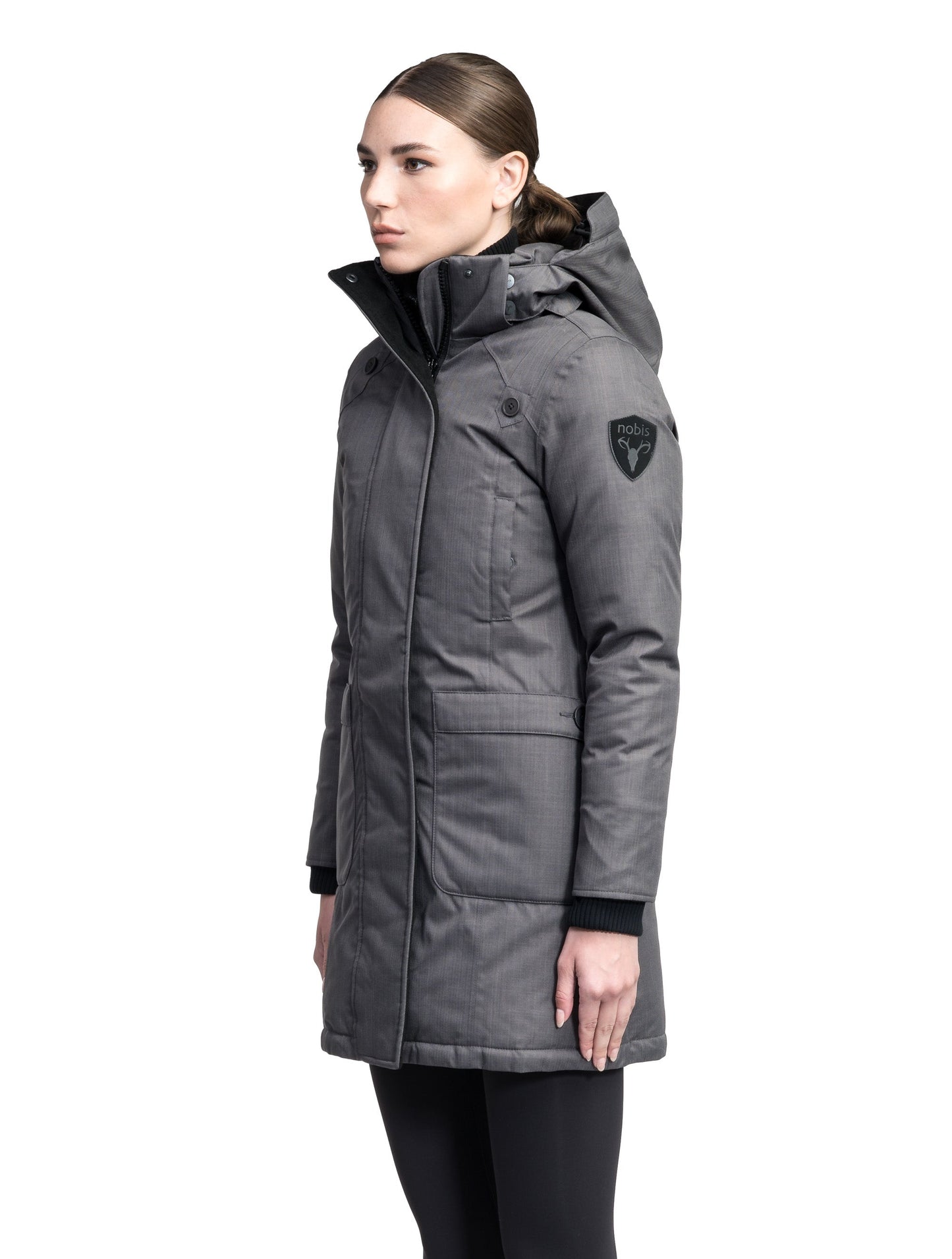 Merideth Furless Ladies Parka in thigh length, Canadian white duck down insulation, removable down-filled hood, centre-front two-way zipper with magnetic wind flap closure, four exterior pockets, and elastic ribbed cuffs, in Steel Grey