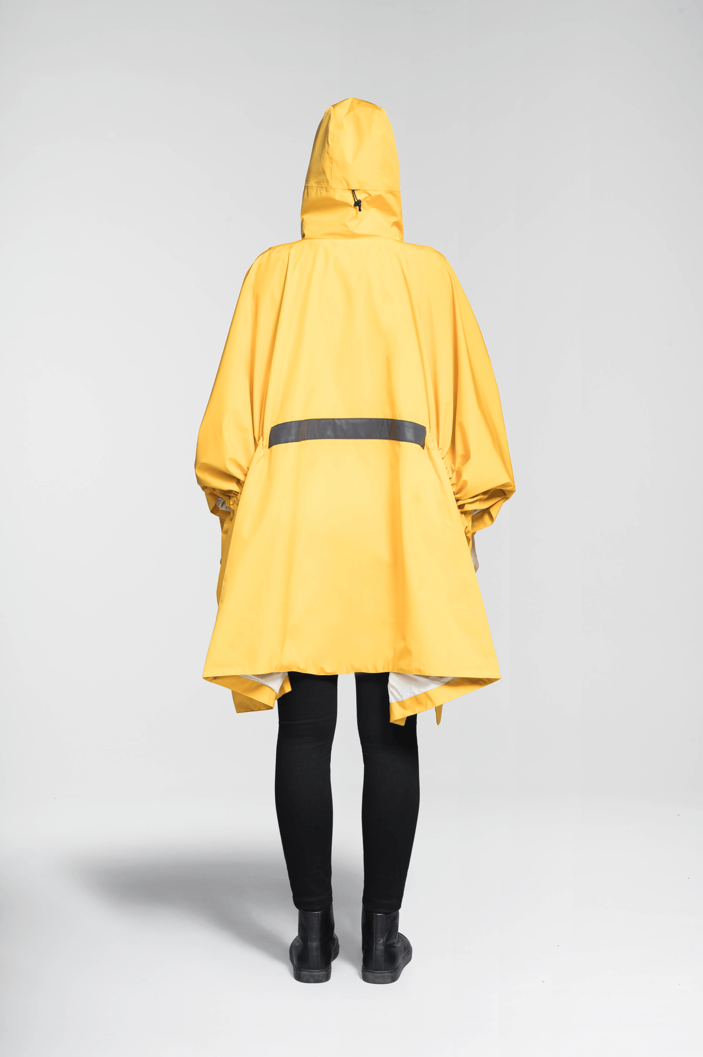 Hydra Unisex Performance Poncho in thigh length, non-removable hood, vertical half-zipper along centre front collar, hidden side-entry waist zipper pockets, adjustable webbing straps and snap closure cuffs, and packable to front kangaroo pocket with flap opening, in Old Gold