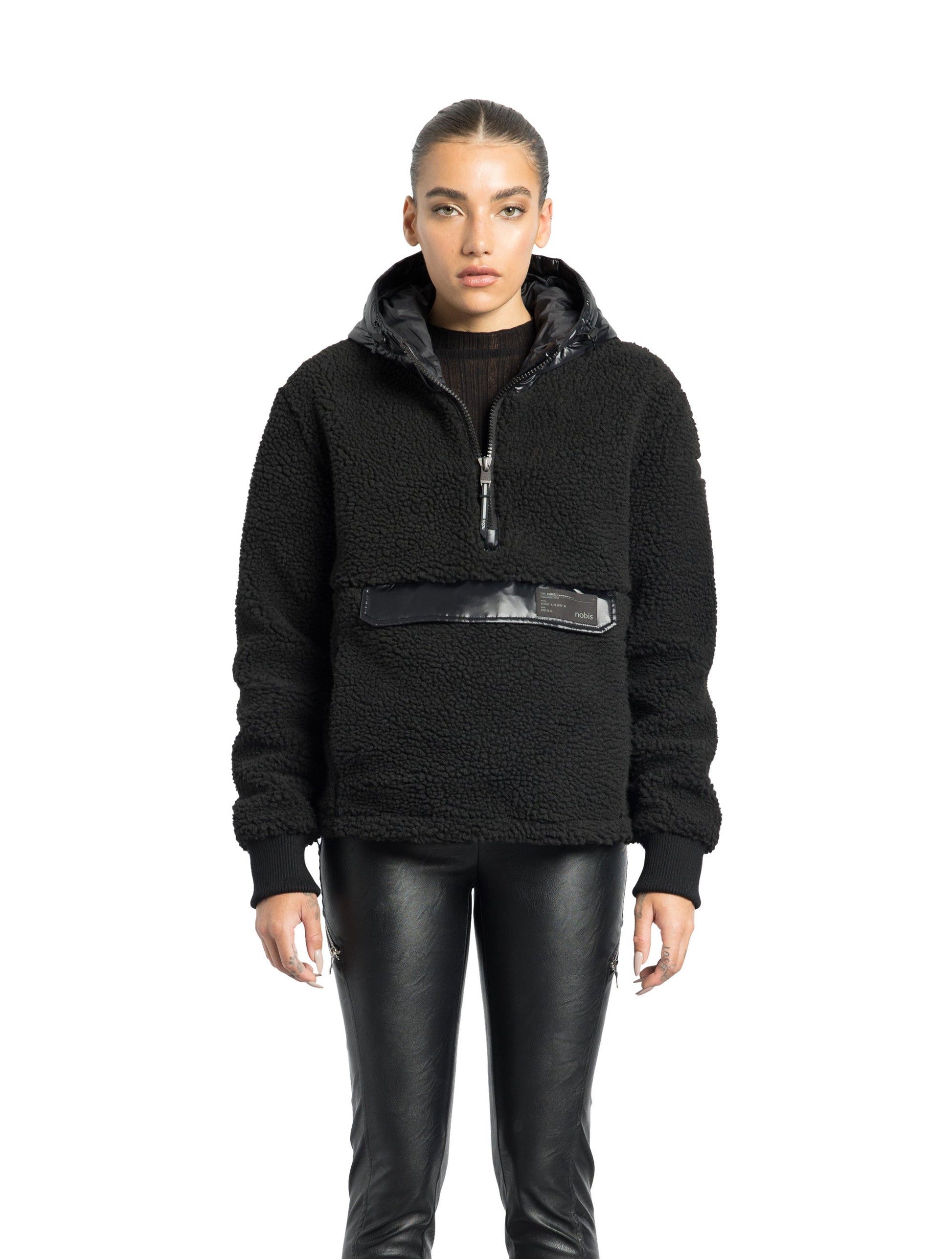 Roche Women's Hybrid Berber Pullover Hoodie in hip length, premium berber and cire technical nylon taffeta fabrication, Primaloft Gold Insulation Active+, non-removable hood with zipper at collar, kangaroo pocket with magnetic closure flap and additional side-entry pockets, ribbed cuffs, adjustable drawcords at side hem, in Black