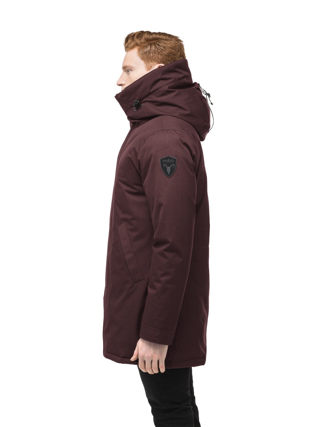 Pierre Men's Jacket in thigh length, Canadian white duck down insulation, non-removable down-filled hood, angled waist pockets, centre-front zipper with wind flap, and elastic ribbed cuffs, in Merlot